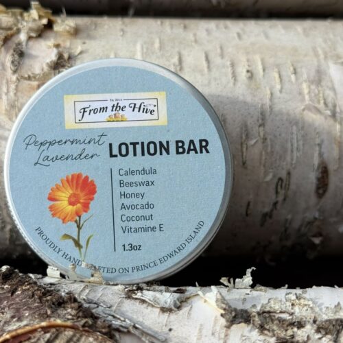 A 60ml (2oz.) silver aluminum tin with screw top holds a 1.3oz solid Calendula Peppermint Honey moisturizing lotion bar with a honey bee imprint.