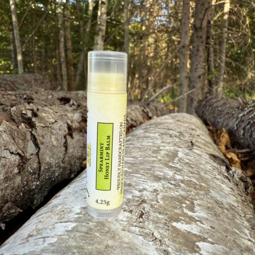 Hydrating Spearmint Honey lip balm with infused raw honey and added shea butter, apricot kernel, beeswax, avocado, jojoba and vitamin E in a 4.25g clear plastic lip balm tube.